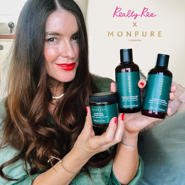 Woman holding MONPURE haircare products including shampoo, conditioner, and scalp scrub with green labels