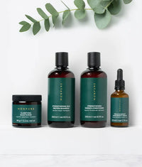 Set of four Monpure hair care products including scalp scrub, shampoo, conditioner, and hair density serum with green labels