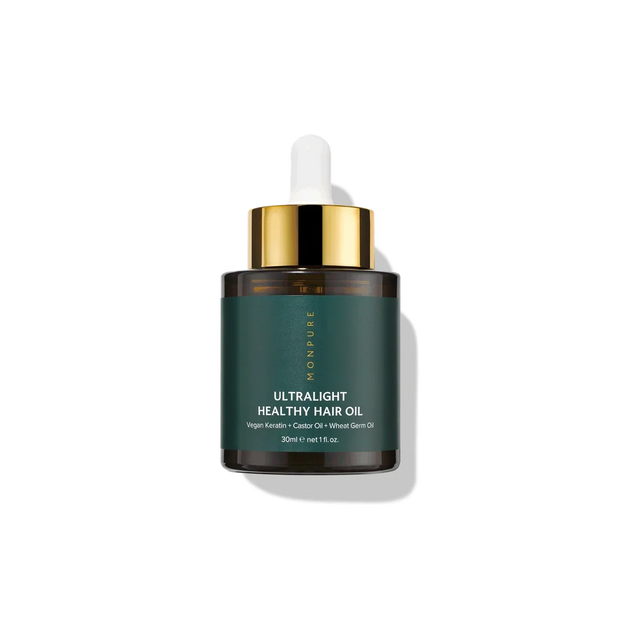 30ml dark amber glass bottle of ultralight healthy hair oil with green label and gold dropper cap