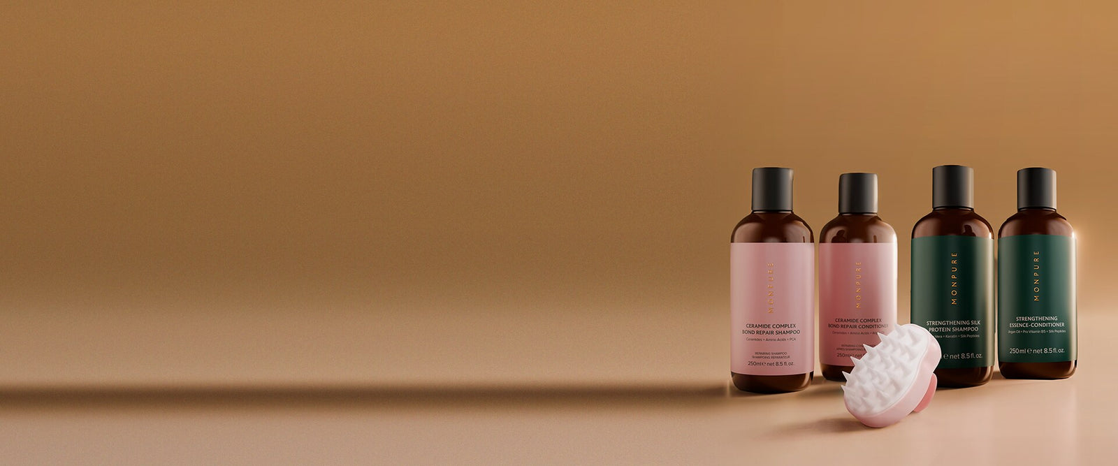 MONPURE Ceramide and Strengthening shampoo and conditioner bottles with free pink scalp massage brush on caramel background, desktop banner