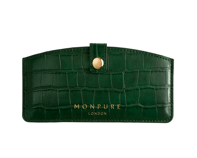 Dark green crocodile-effect leather travel case with gold button and Monpure London branding
