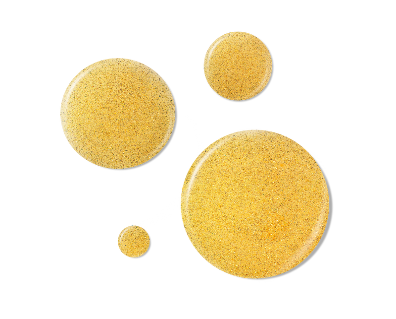Golden shimmer droplets of hydrating hair and body oil with sparkling glitter particles