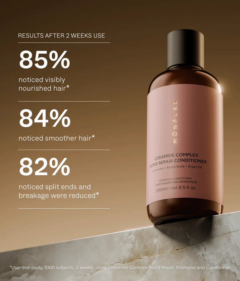 Brown bottle of Ceramide Complex Bond Repair Conditioner with pink label on marble surface