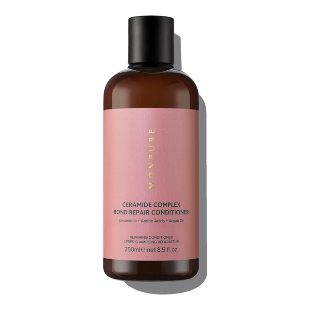Brown bottle with pink label containing Ceramide Complex Bond Repair Conditioner with argan oil