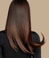 Smooth, shiny brown hair with a healthy finish, styled straight and slightly curled at the end