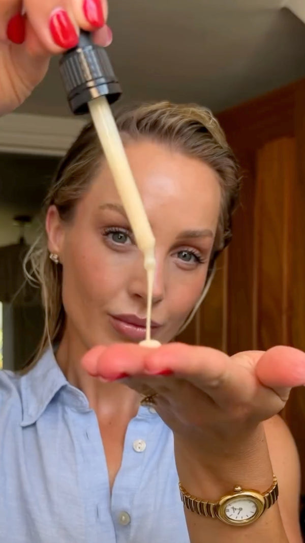 Chloe Rose dispensing MONPURE scalp serum from a dropper onto her hand