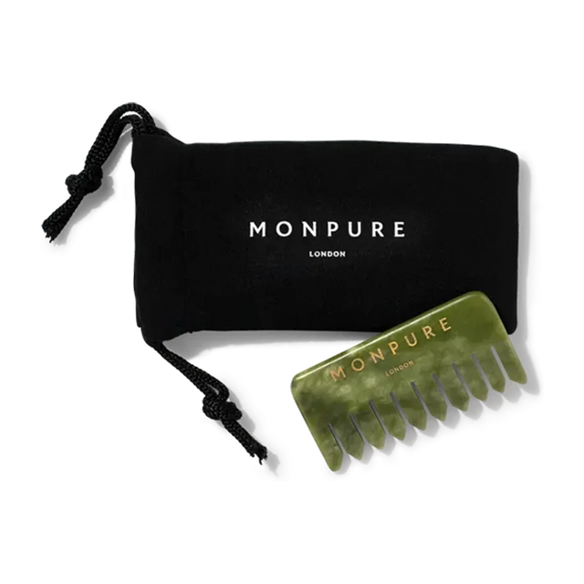 Green jade comb with wide teeth and gold Monpure branding, accompanied by black drawstring pouch