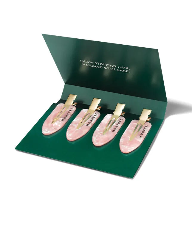 Set of four pink marbled no-crease hair clips with gold-tone clasps in green presentation box