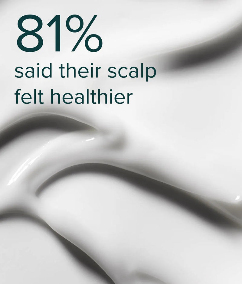 Close-up of smooth white creamy scalp mask texture with text about healthier scalp benefits