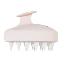 Soft pink scalp massage brush with white silicone bristles and ergonomic handle