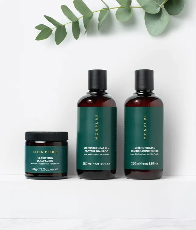 Set of three Monpure haircare products including clarifying scalp scrub, strengthening silk protein shampoo, and essence-conditioner with green labels