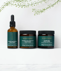 Monpure Triple-Hydration Hit Regime with scalp serum, mask, and scrub in amber and green containers