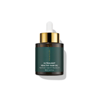 30ml dark amber glass bottle of ultralight healthy hair oil with green label and gold dropper cap
